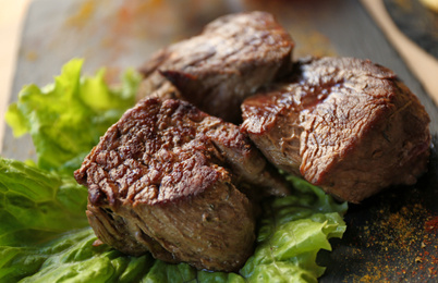 Tasty pieces of shish kebab served on slate plate in cafe