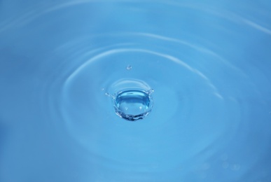 Photo of Splash of blue water as background, closeup