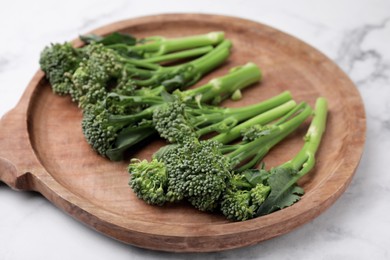 Fresh raw broccolini on white marble table, closeup. Healthy food