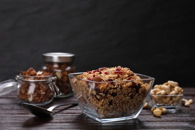 Tasty granola served with nuts and dry fruits on wooden table