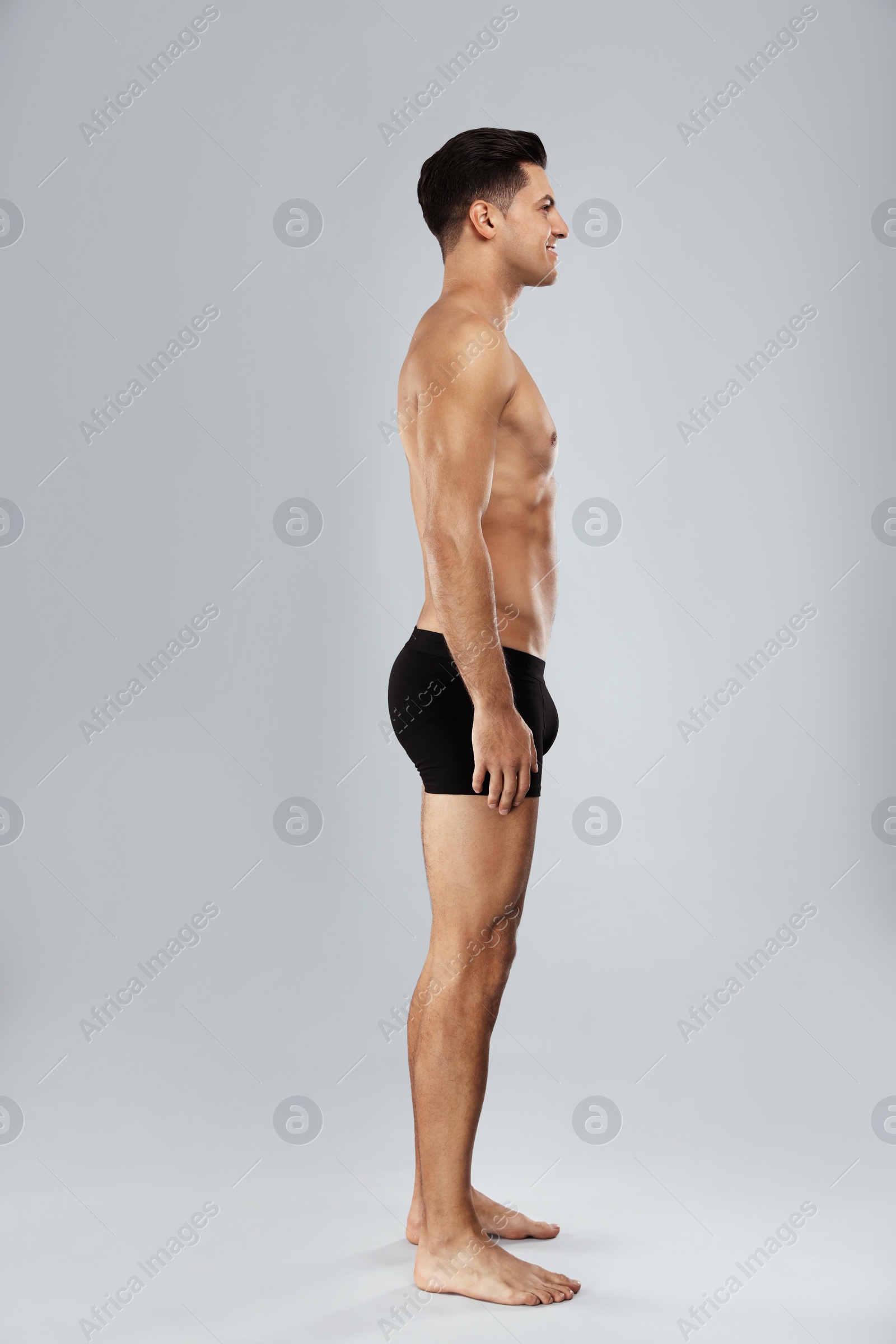 Photo of Handsome man in black underwear on light grey background