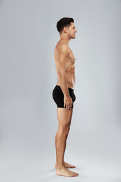 Photo of Handsome man in black underwear on light grey background