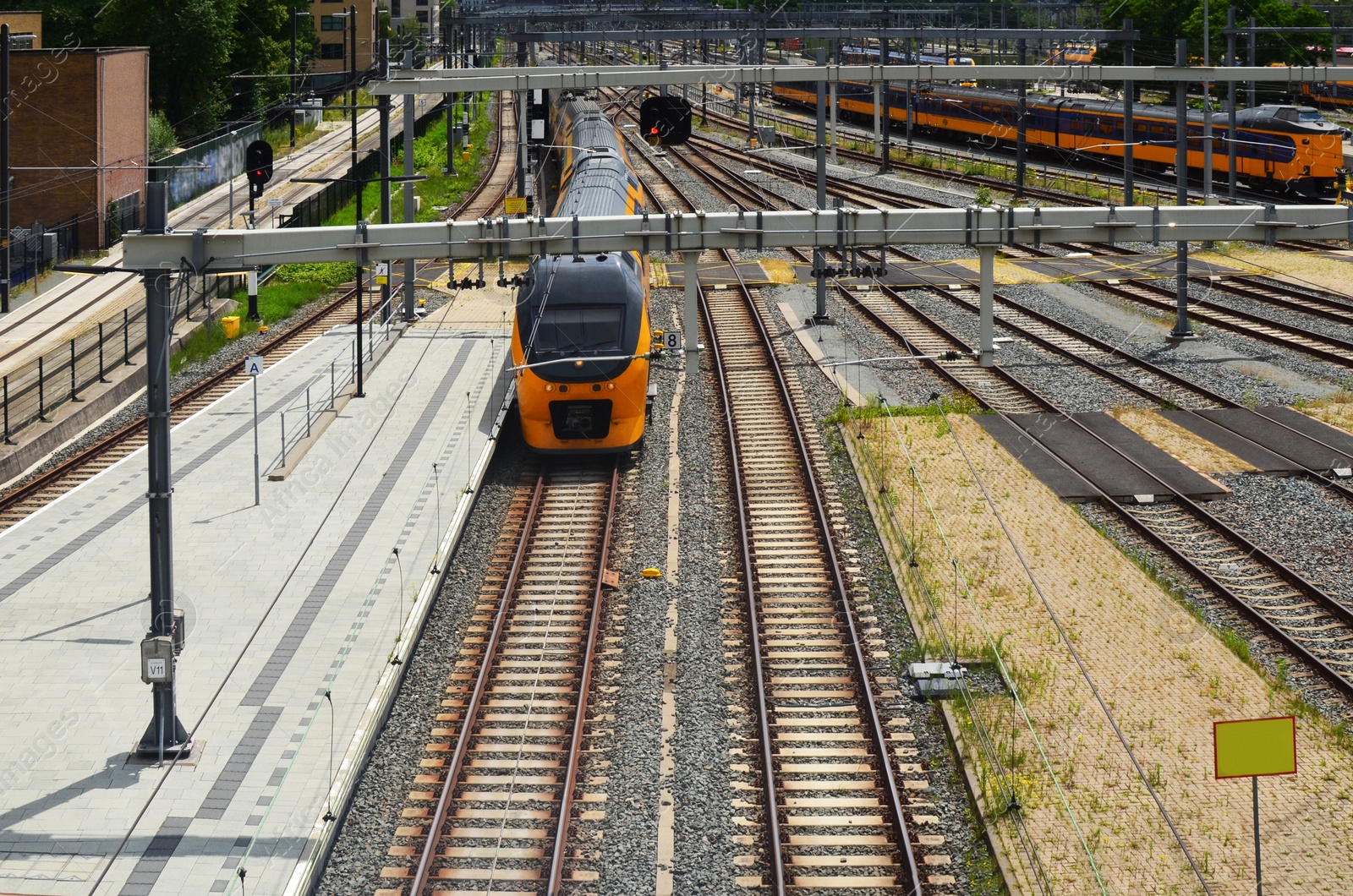Photo of Railway lines and modern trains on sunny day