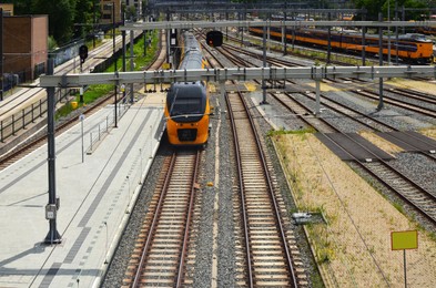 Railway lines and modern trains on sunny day