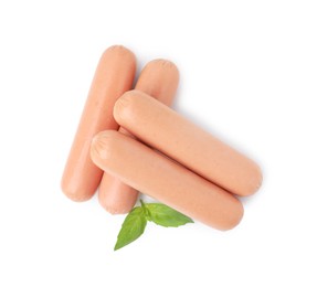 Photo of Delicious boiled sausages and basil on white background, top view