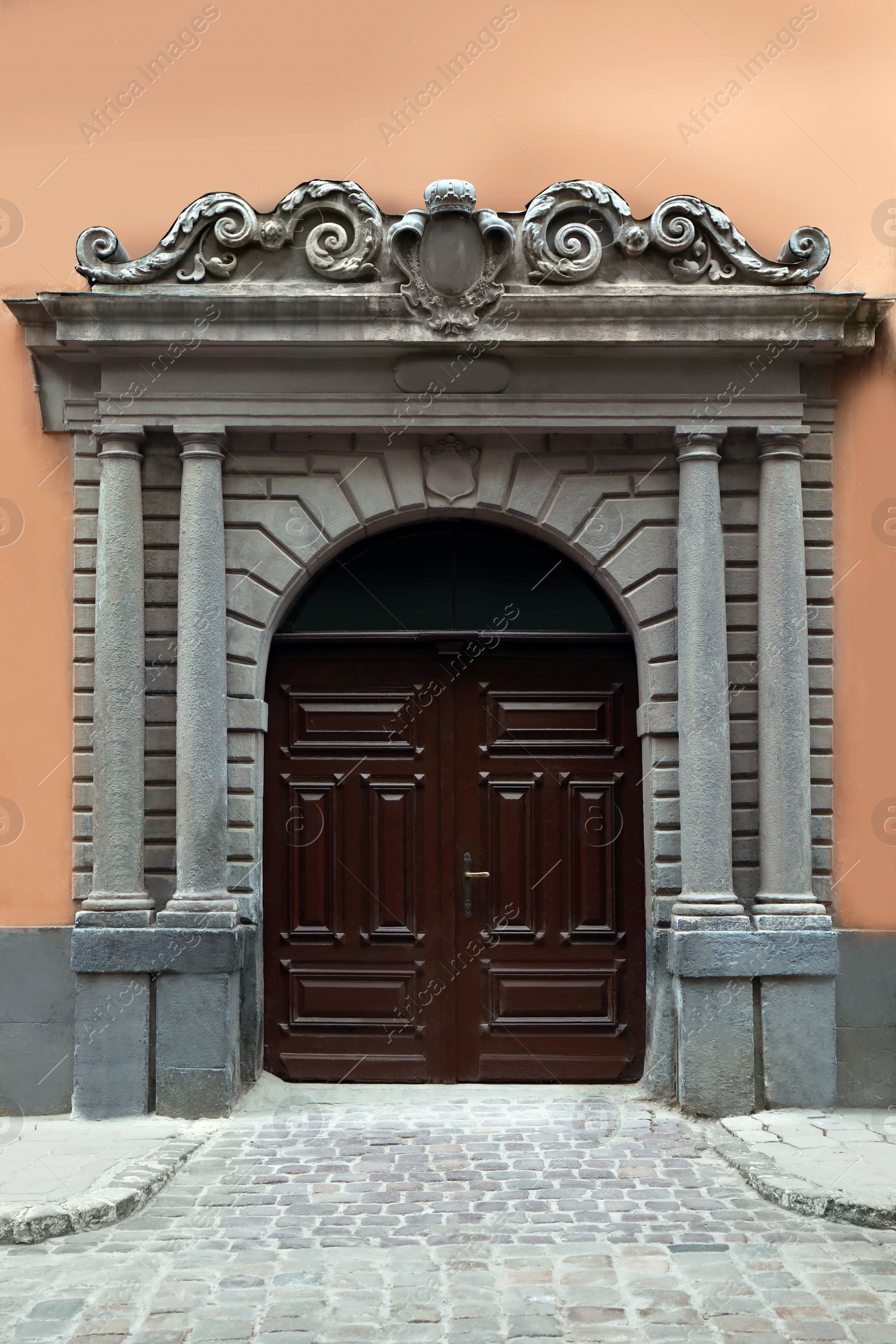 Photo of View of house with beautiful arched wooden door. Exterior design