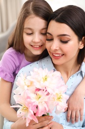 Little daughter congratulating her mom, closeup. Happy Mother's Day