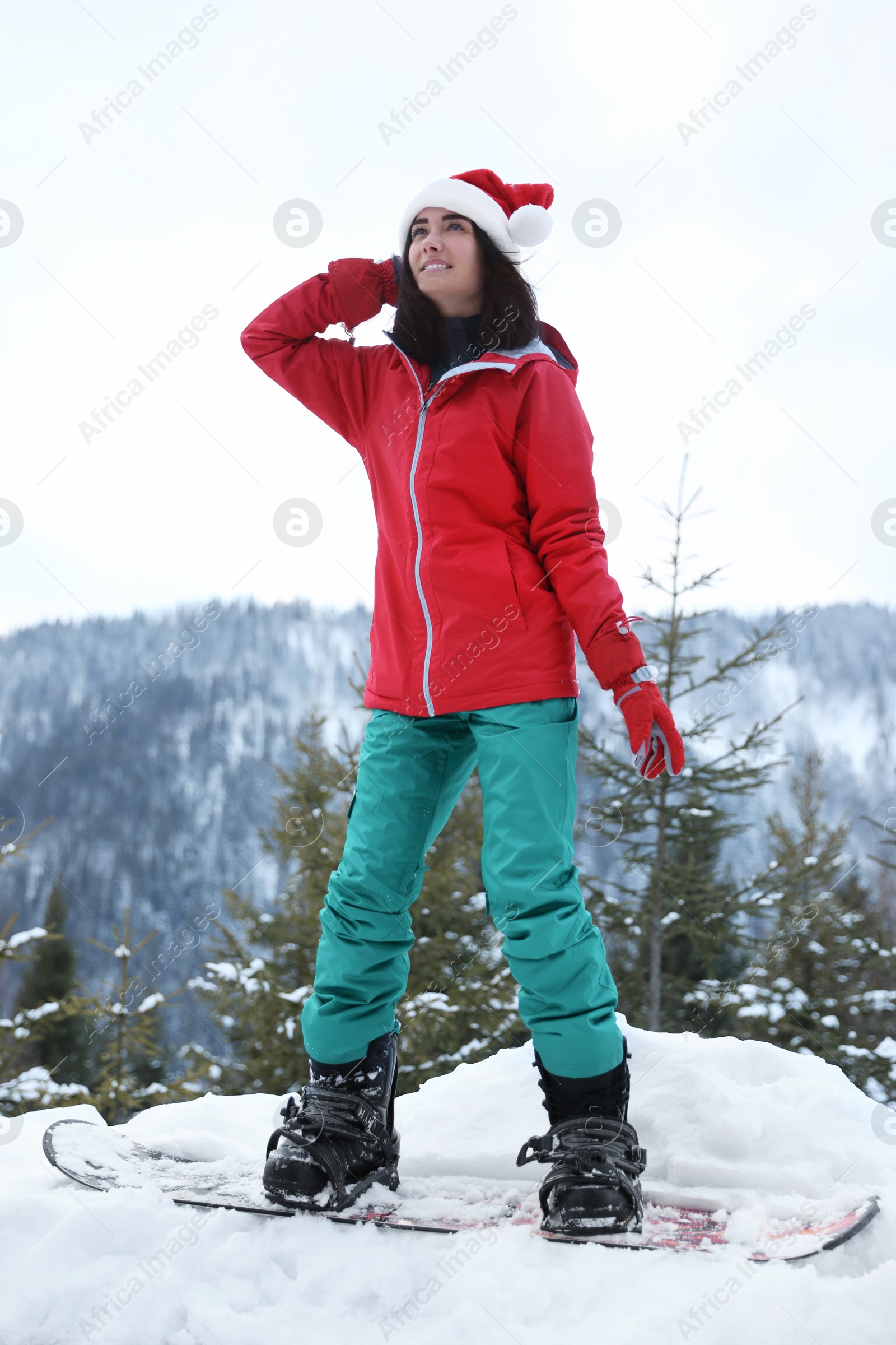 Photo of Young snowboarder wearing winter sport clothes on hill