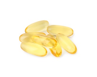 Photo of Many yellow vitamin capsules isolated on white