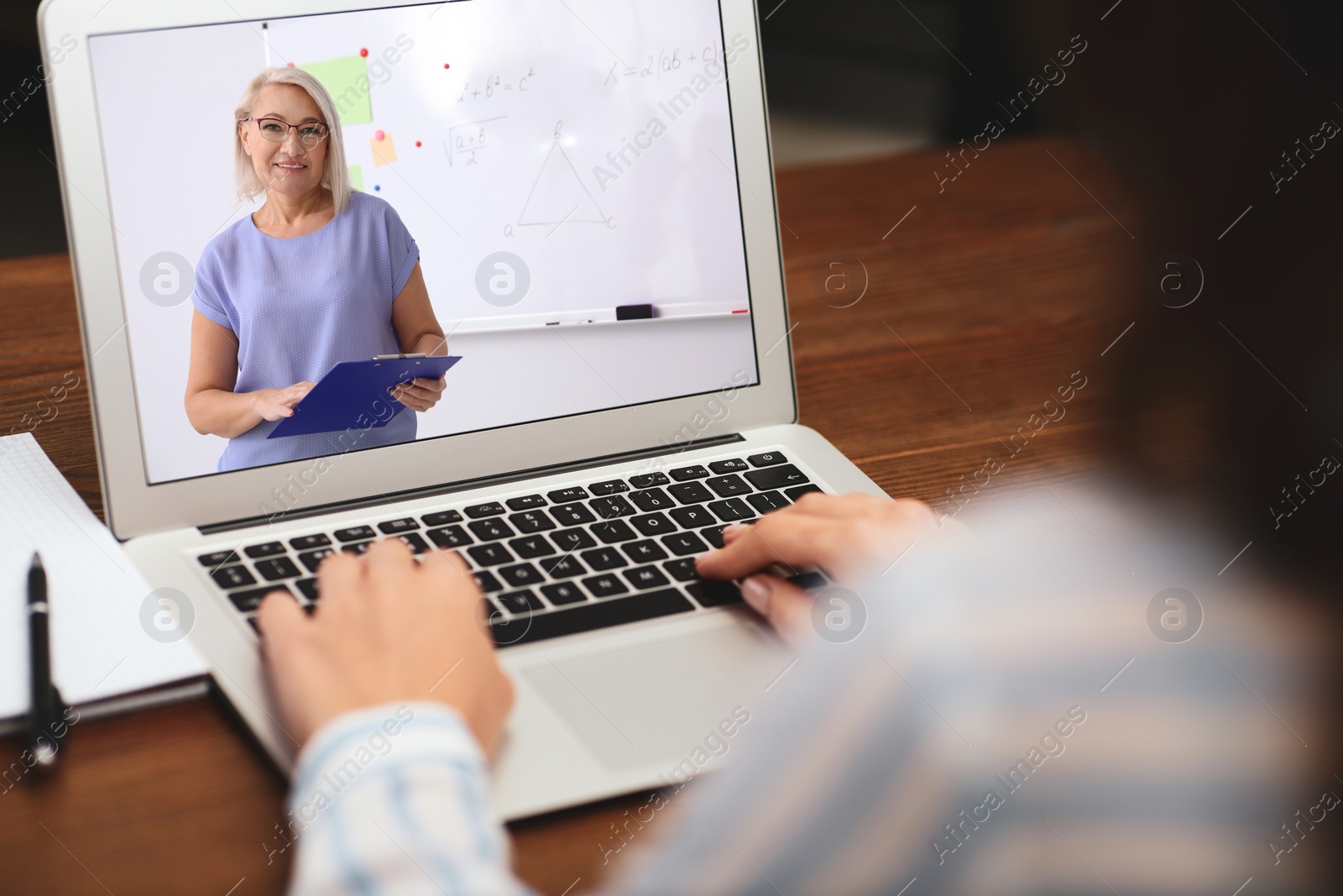 Image of Young woman watching video at desk, closeup. Online learning
