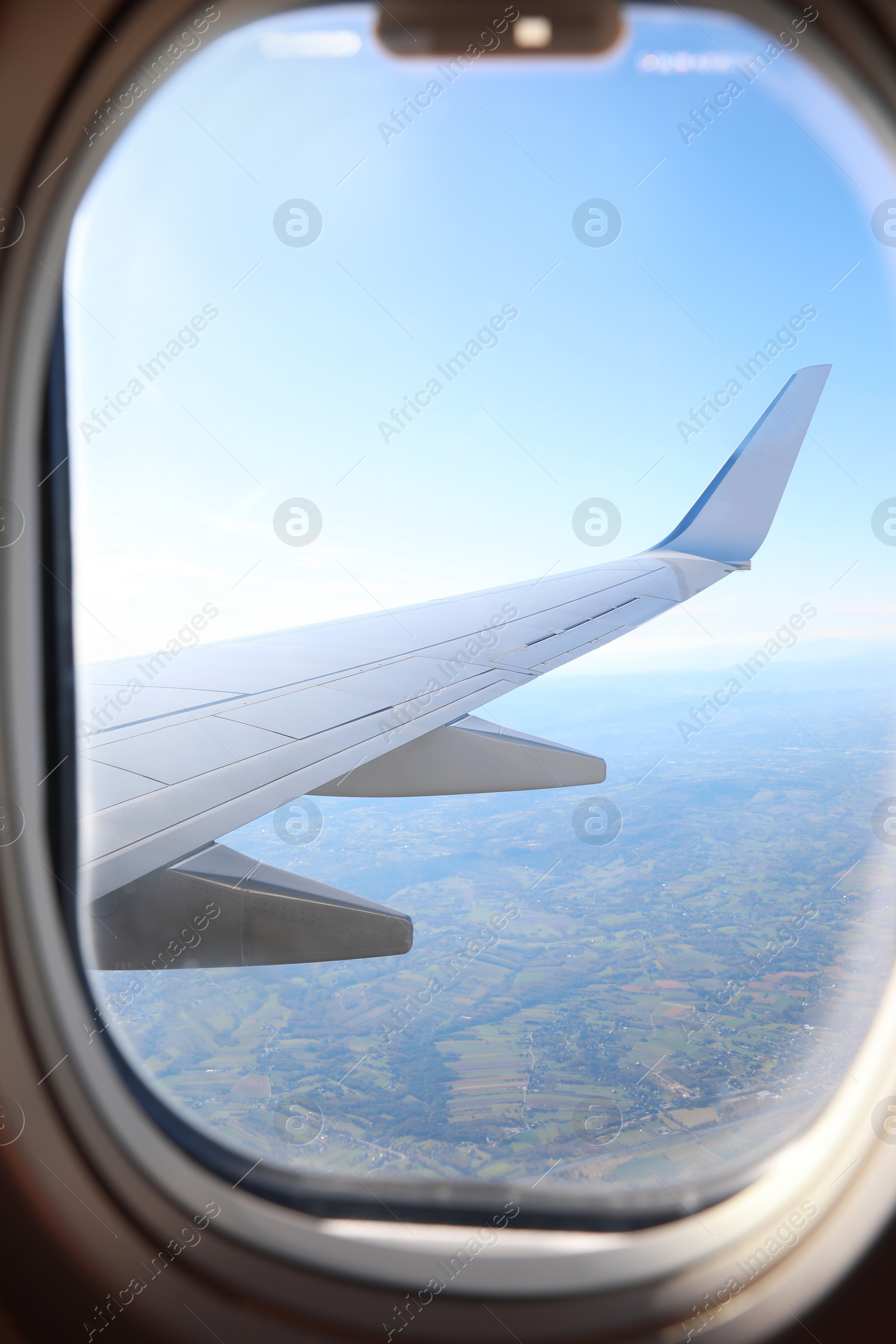 Photo of Beautiful view through airplane window during flight. Traveling abroad