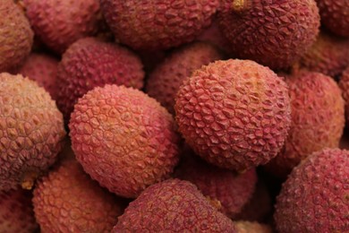 Pile of fresh ripe lychees as background, top view