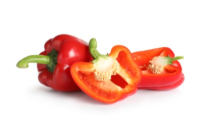 Cut and whole ripe red bell peppers on white background