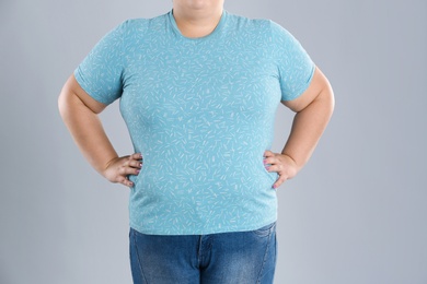 Overweight woman before weight loss on color background