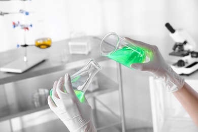 Photo of Scientist doing analysis in lab, closeup. Solution chemistry