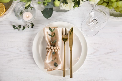 Elegant festive table setting on white wooden background, flat lay