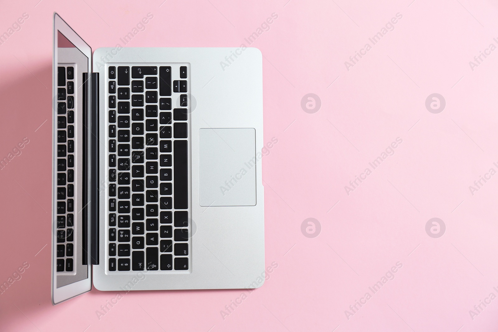 Photo of Modern laptop on color background, top view