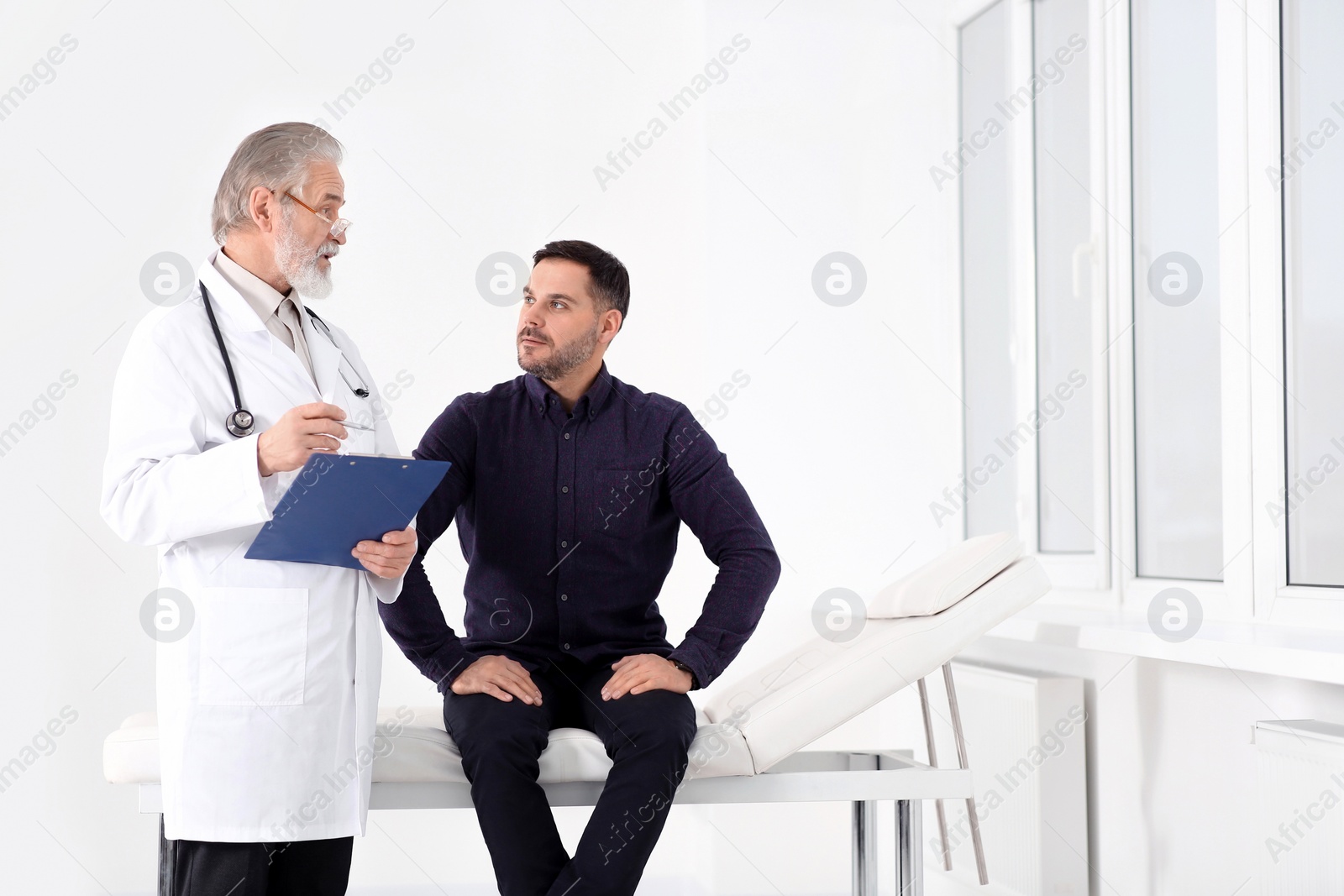 Photo of Patient having appointment with senior doctor in clinic