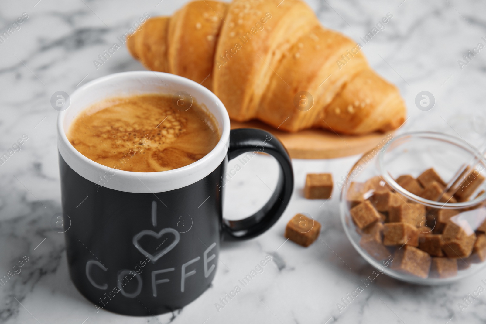 Photo of Delicious morning coffee, sugar and croissant on white marble table