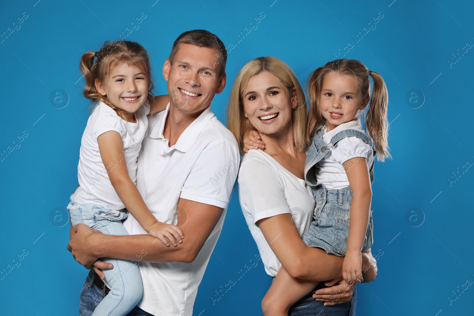 Photo of Happy family with children on blue background