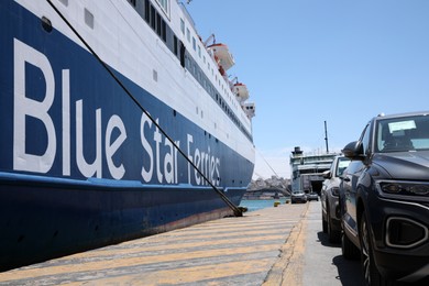 PIRAEUS, GREECE - MAY 19, 2022: Picturesque view of port with Blue Star ferry and cars on sunny day