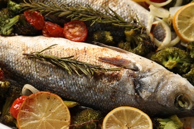 Photo of Delicious fish with vegetables and lemon, closeup