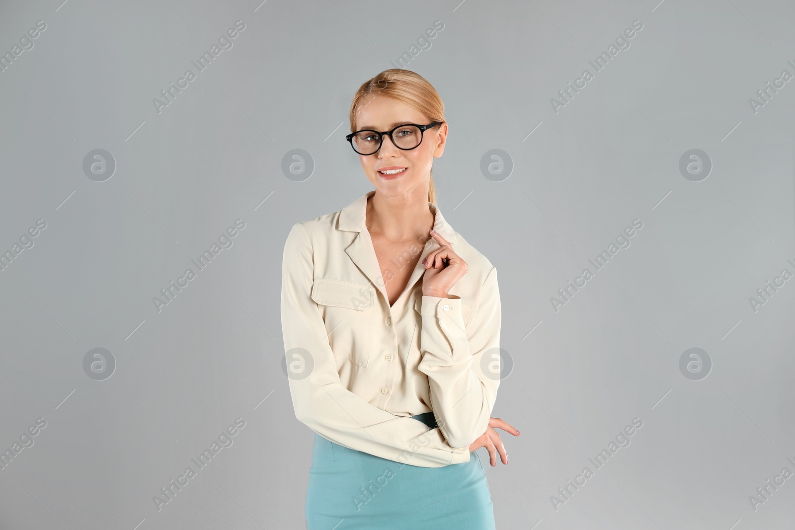 Photo of Portrait of young businesswoman on grey background