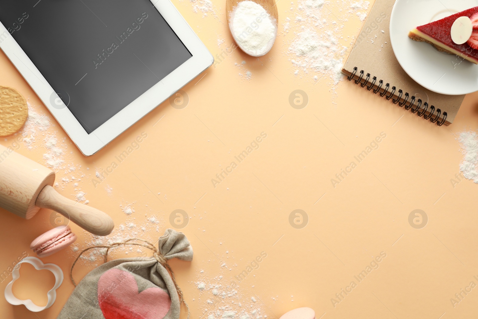 Photo of Flat lay composition with tablet on beige background. Food blogger's workplace