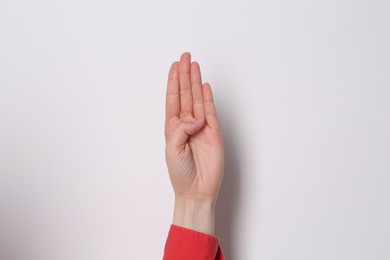 Woman showing open palm on white background, closeup
