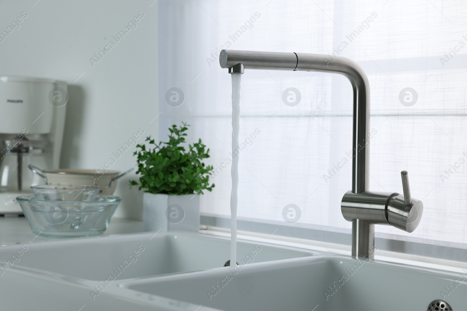 Photo of Stream of water flowing from tap in kitchen, space for text