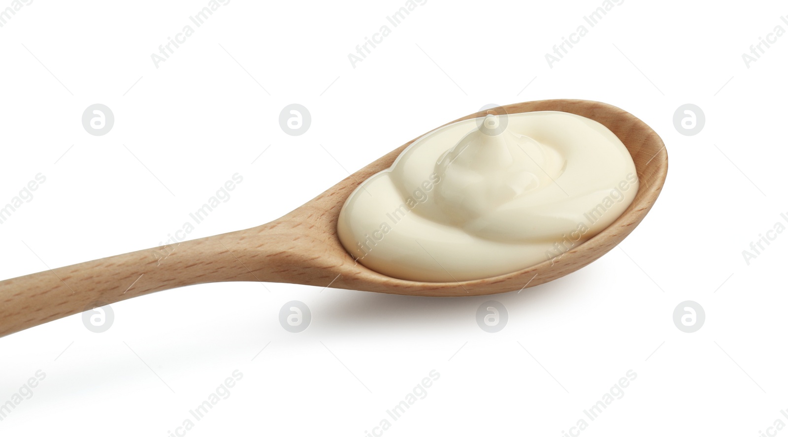 Photo of Fresh mayonnaise sauce in wooden spoon isolated on white