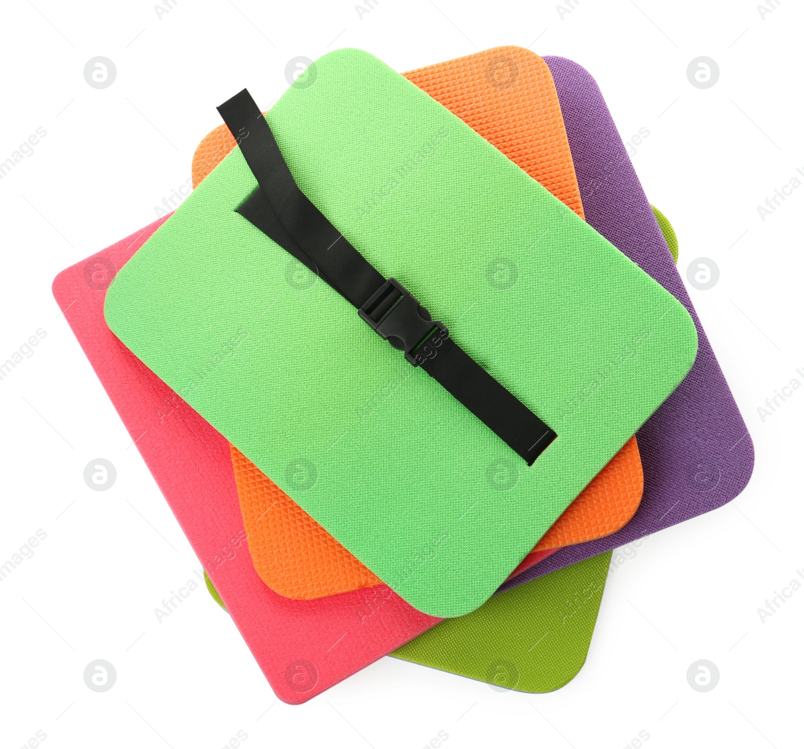 Photo of Bright foam tourist seat mats isolated on white, top view