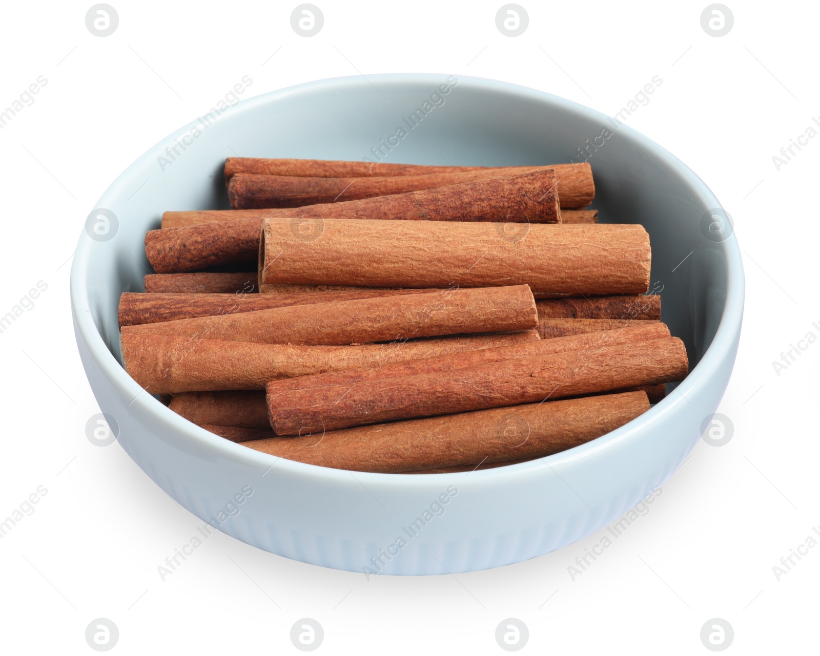 Photo of Aromatic cinnamon sticks in bowl isolated on white