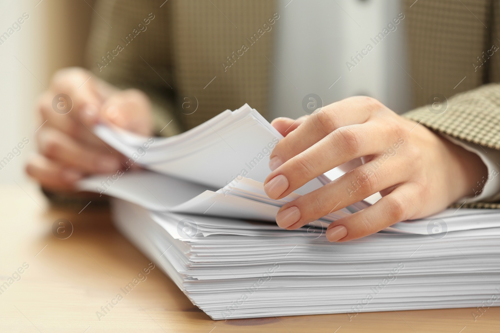 Photo of Woman working with documents at table in office, closeup