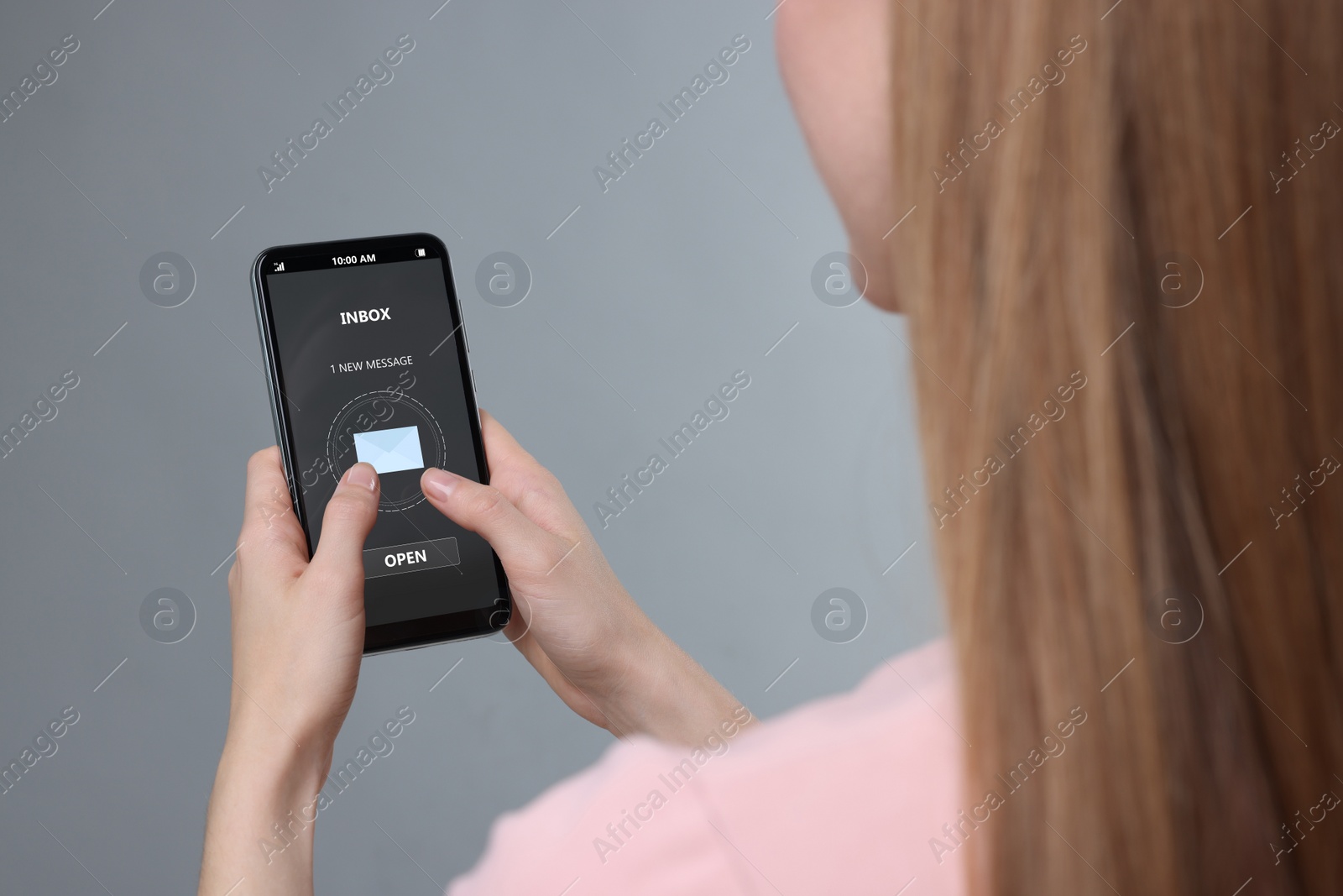Image of Got new message. Woman using smartphone on grey background, closeup