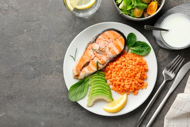 Photo of Healthy food high in vegetable fats served on grey textured table, flat lay. Space for text