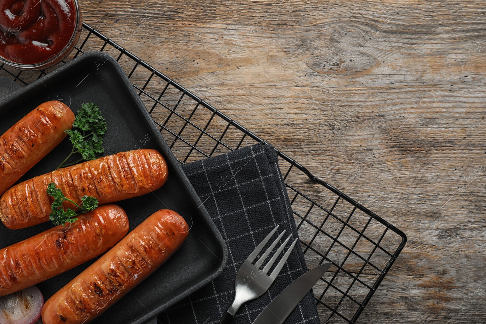 Photo of Flat lay composition with delicious grilled sausages on wooden table. Barbecue food