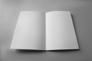 Photo of Open blank brochure on grey background. Mockup for design