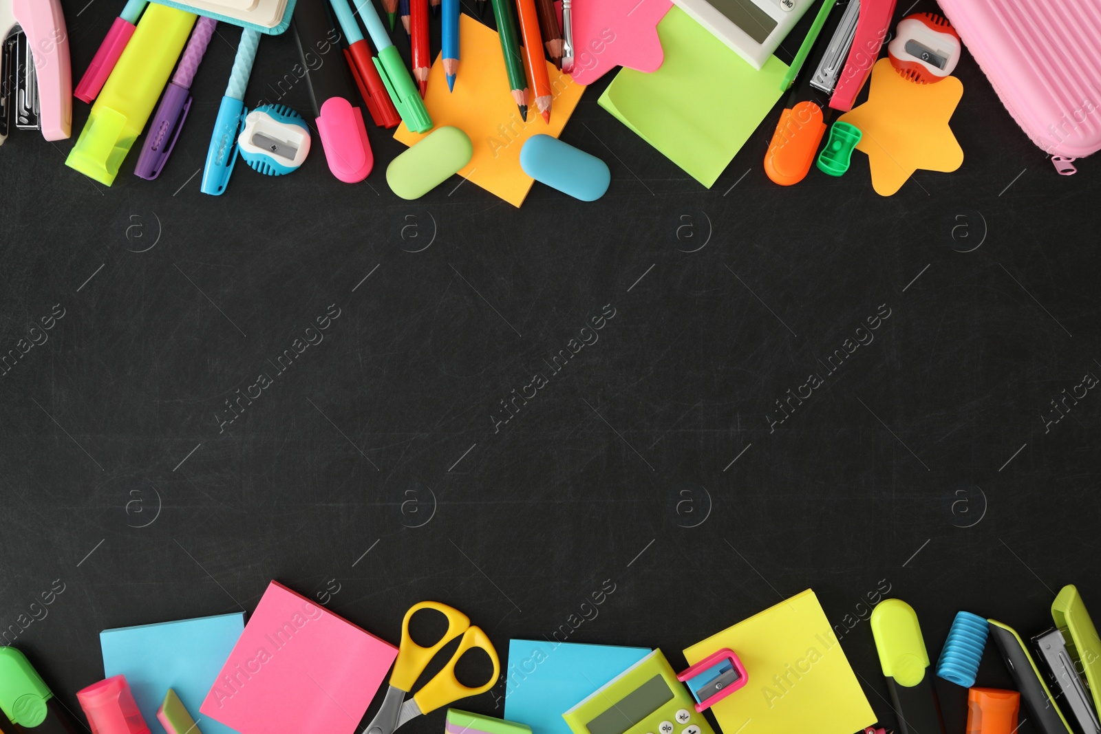 Photo of Frame of different school stationery on blackboard, flat lay and space for text. Back to school