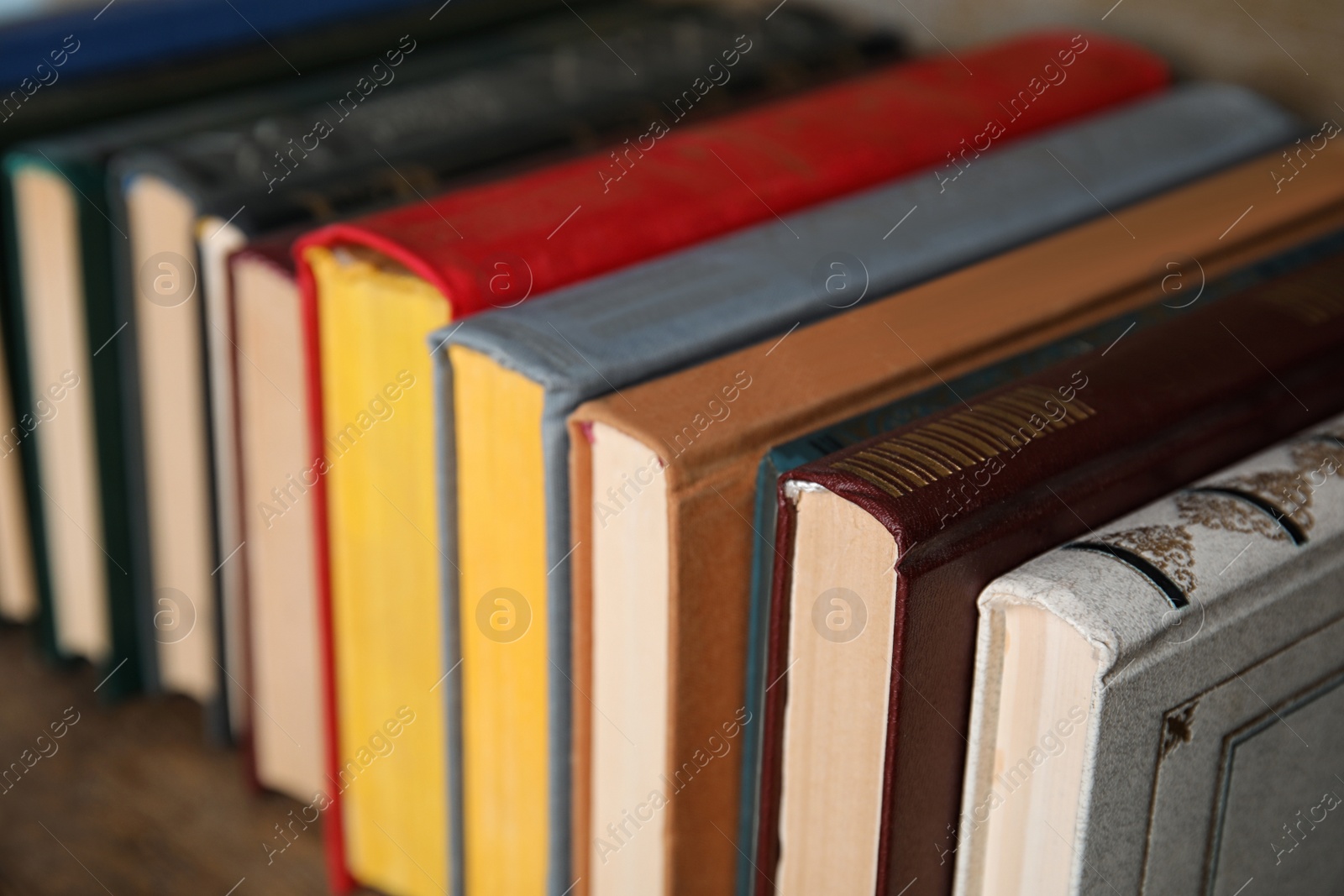 Photo of Stack of hardcover books on table, closeup