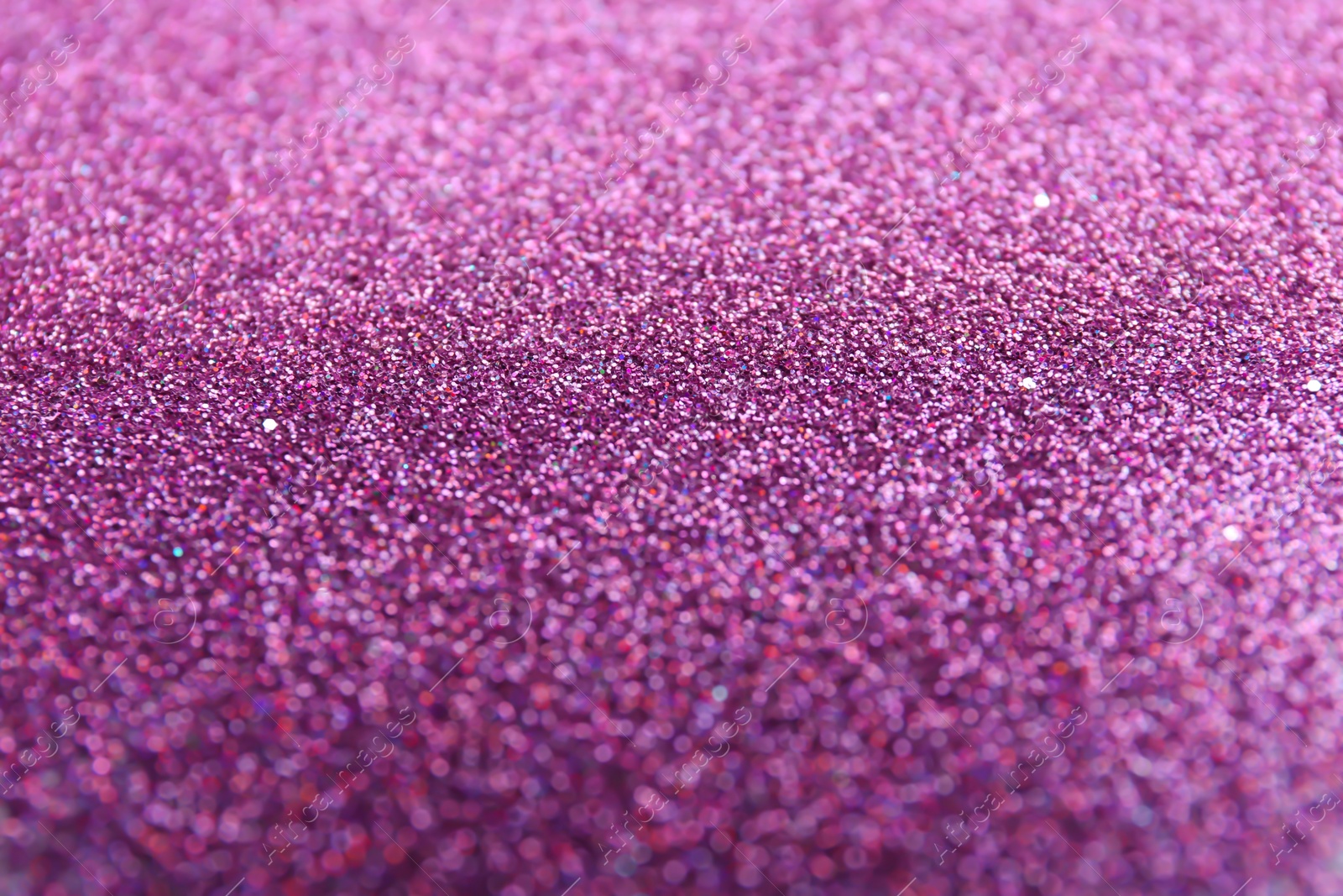 Photo of Closeup view of sparkling violet glitter background