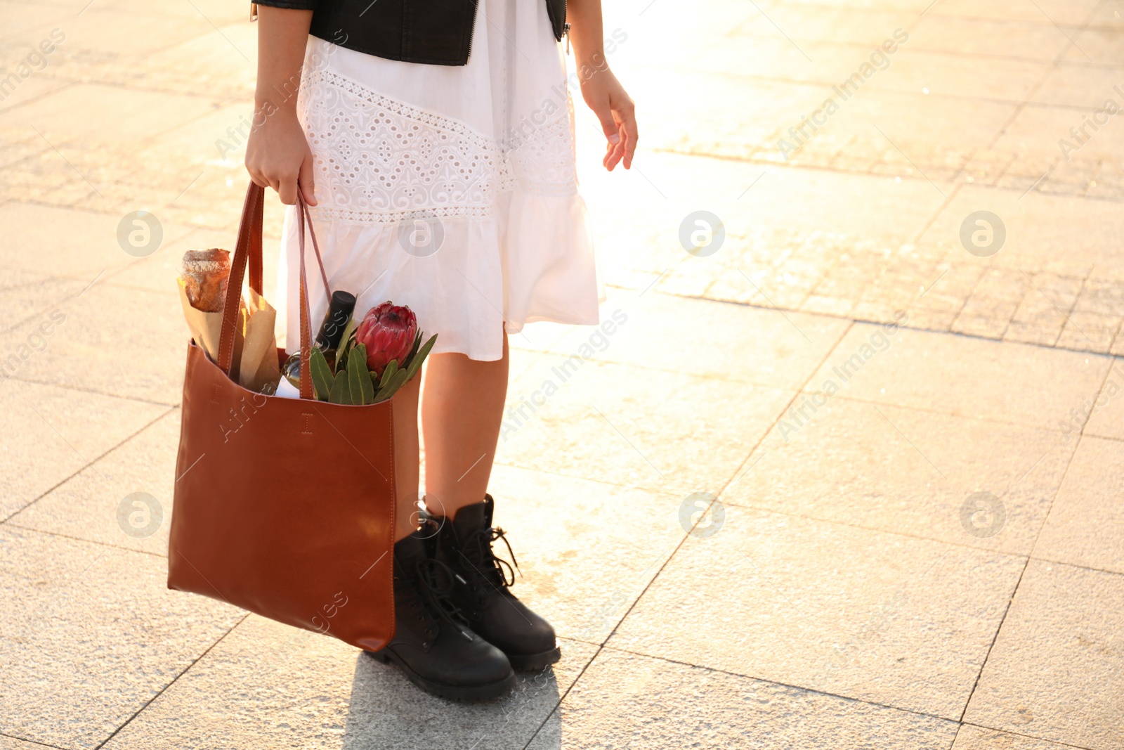 Photo of Woman with leather shopper bag outdoors, closeup