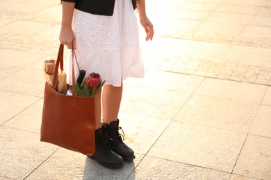 Woman with leather shopper bag outdoors, closeup