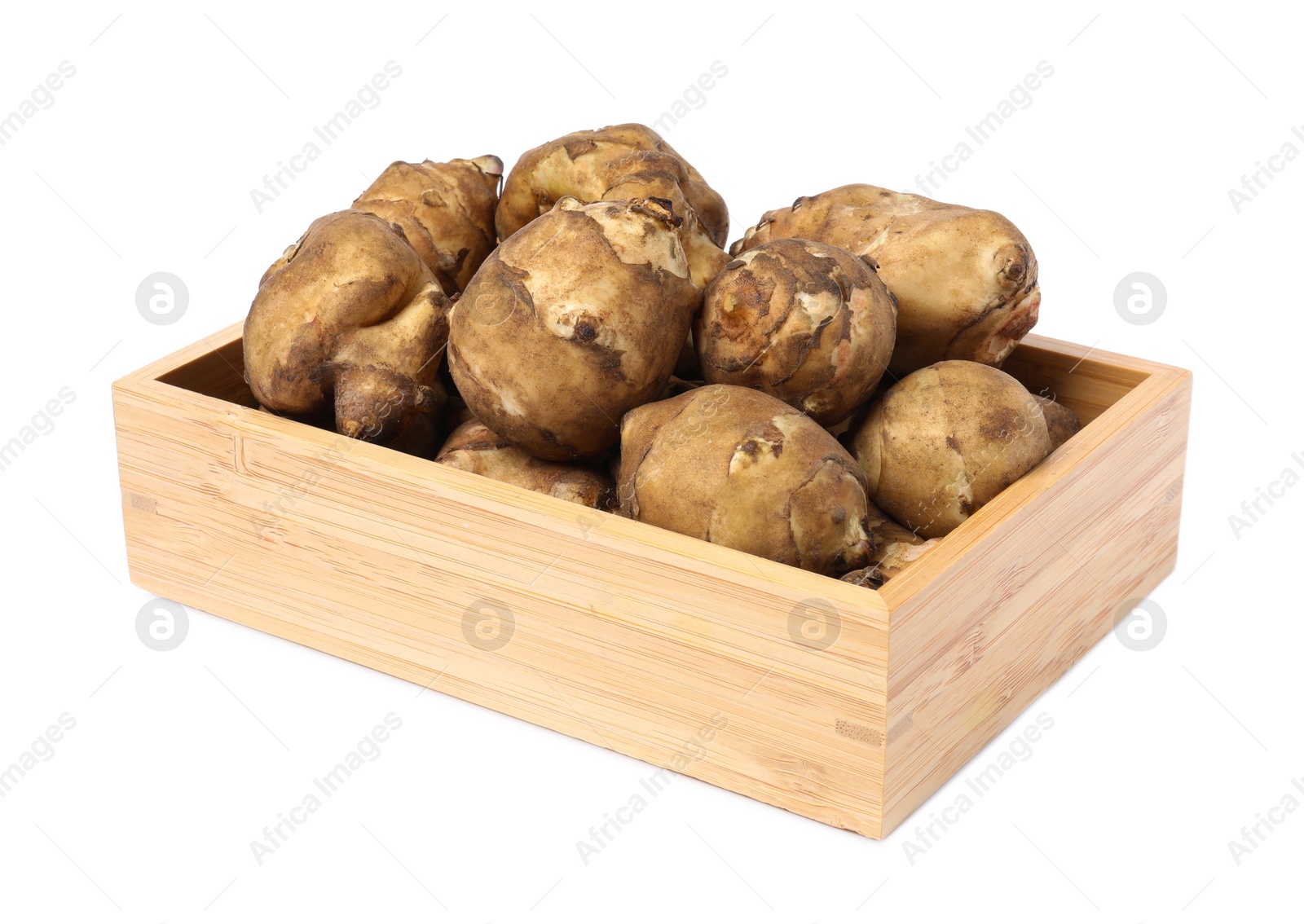 Photo of Wooden crate with fresh Jerusalem artichokes isolated on white