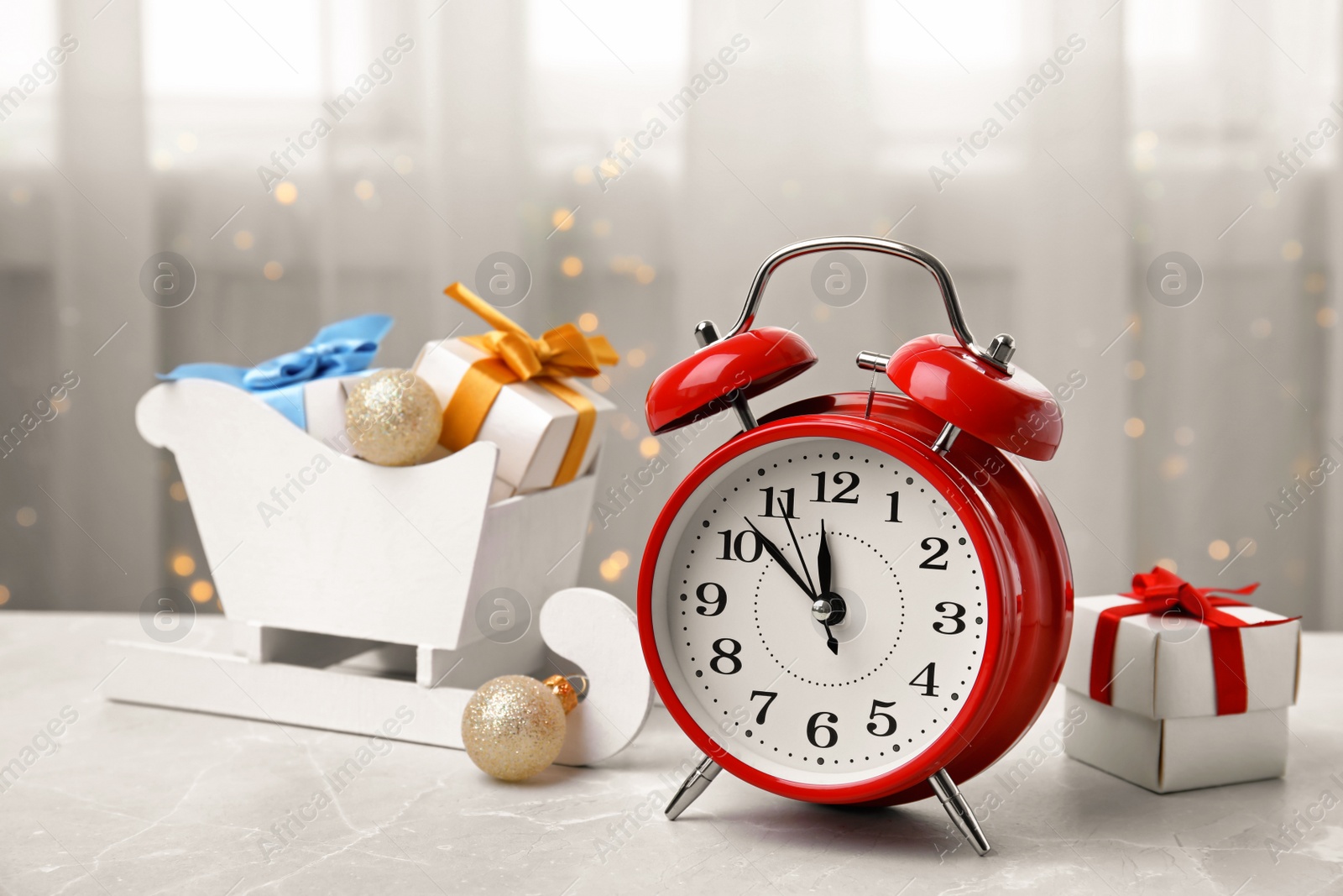 Photo of Retro alarm clock, gifts and festive decor on table. Christmas countdown