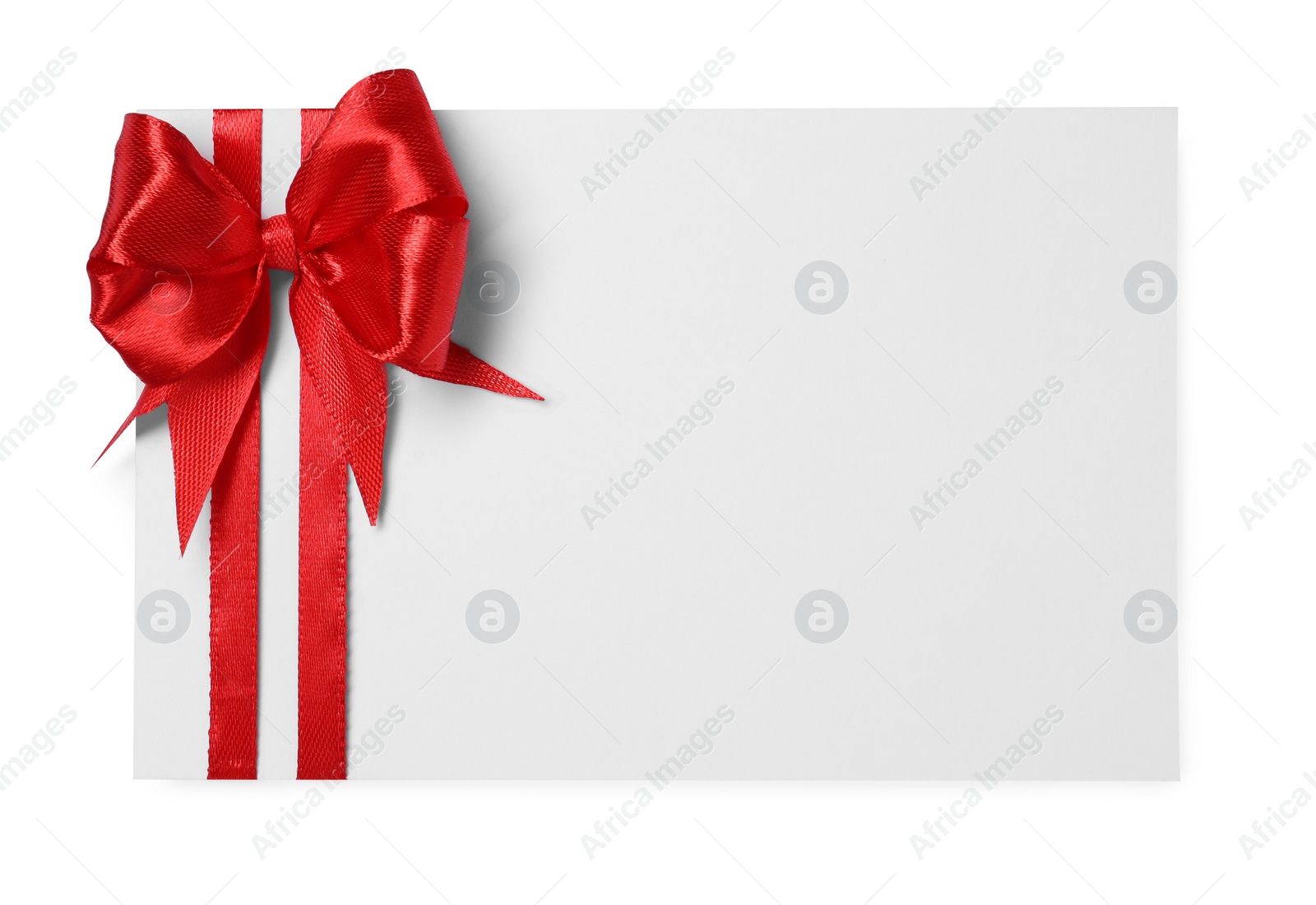 Photo of Blank gift card with red bow isolated on white, top view