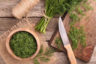 Flat lay composition with fresh dill on wooden table