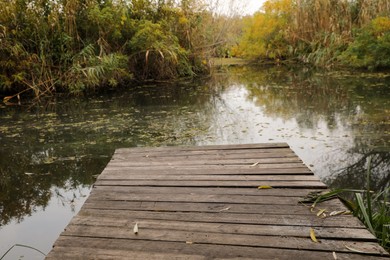Photo of Beautiful wooden pier and lake on autumn day