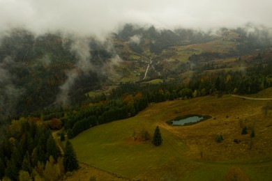 Image of Aerial view of mountains covered with fog