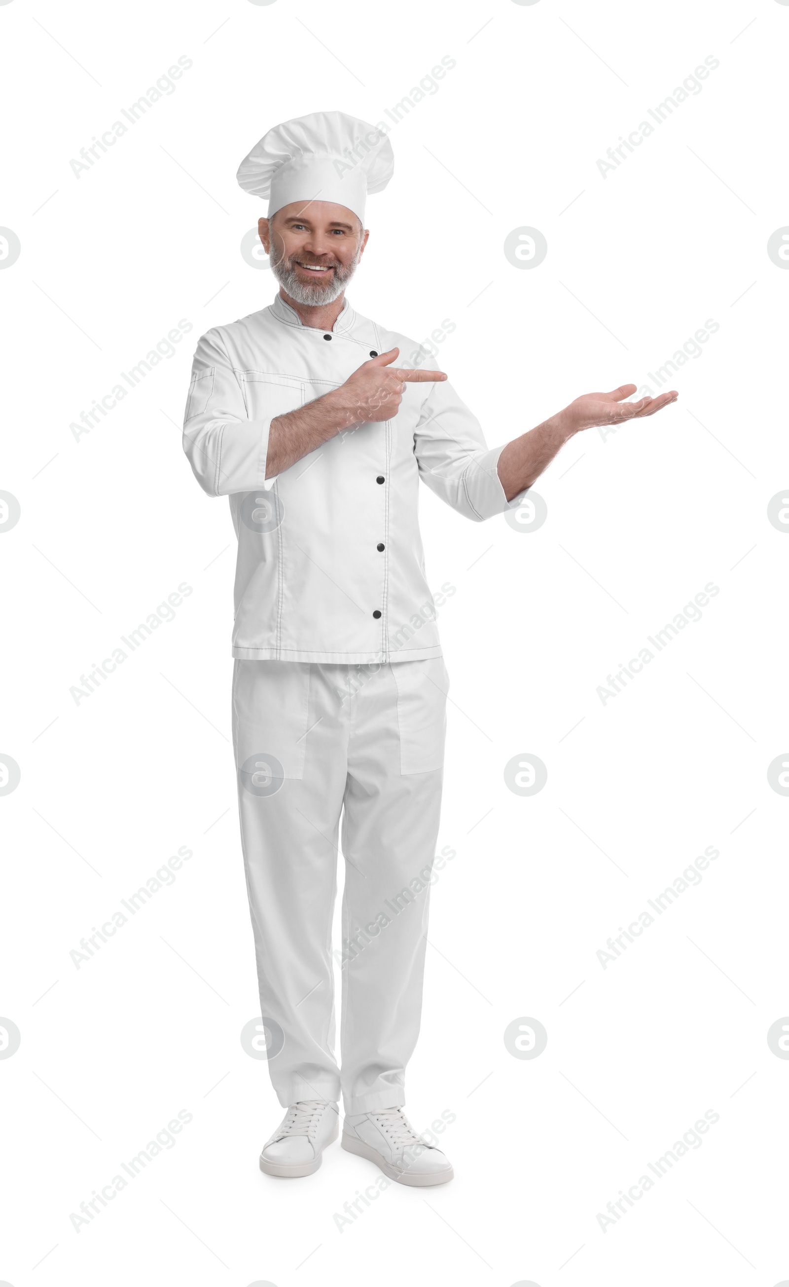 Photo of Happy chef in uniform pointing at something on white background